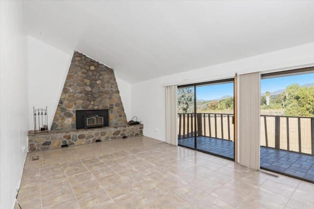 unfurnished living room with light tile patterned floors, visible vents, and vaulted ceiling