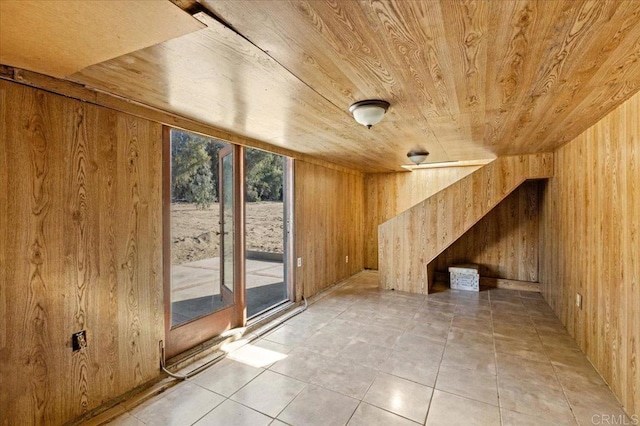 bonus room with wood walls, wood ceiling, and light tile patterned floors