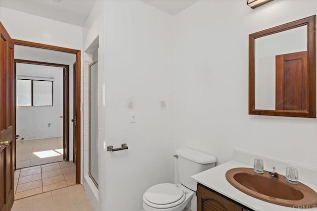 full bath with a shower stall, vanity, toilet, and tile patterned floors