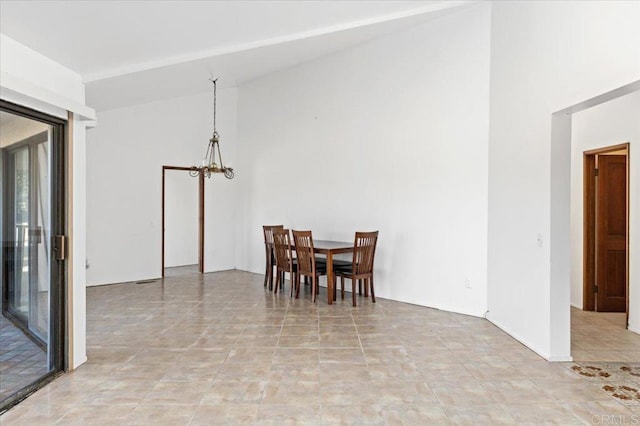 dining space with a chandelier and high vaulted ceiling