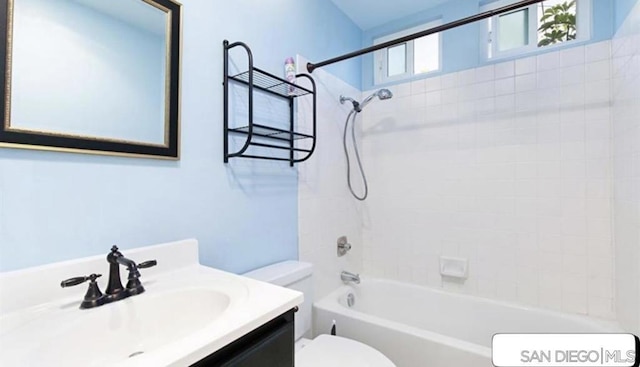 full bathroom with toilet, vanity, and shower / washtub combination