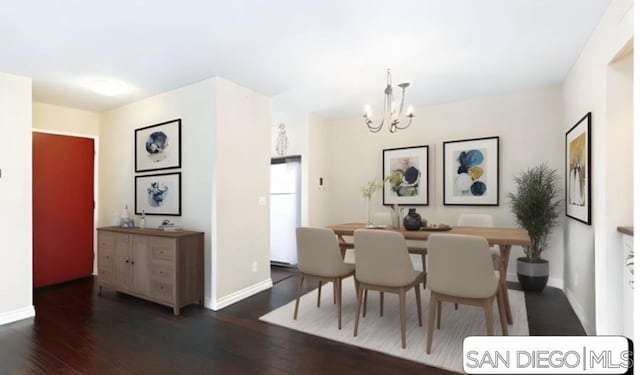 dining room featuring an inviting chandelier and dark wood-type flooring