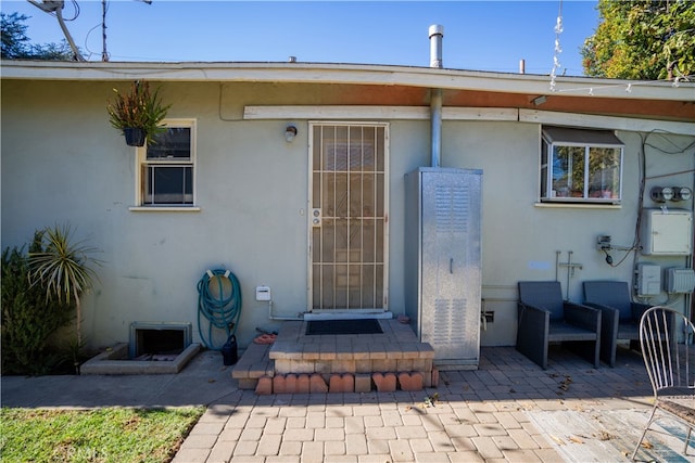 entrance to property featuring a patio