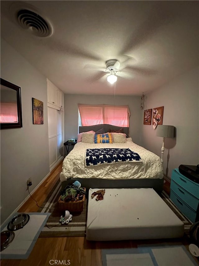 bedroom with ceiling fan and hardwood / wood-style flooring