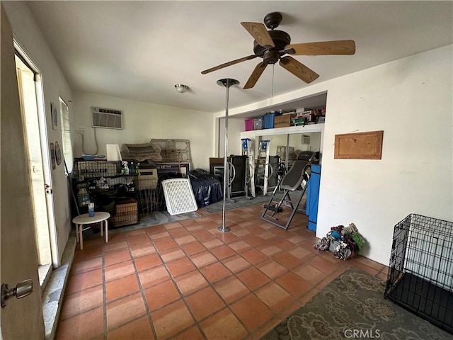 interior space featuring ceiling fan, tile patterned flooring, a healthy amount of sunlight, and a wall mounted air conditioner