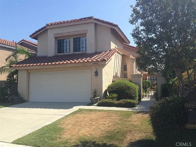 mediterranean / spanish-style home with a garage