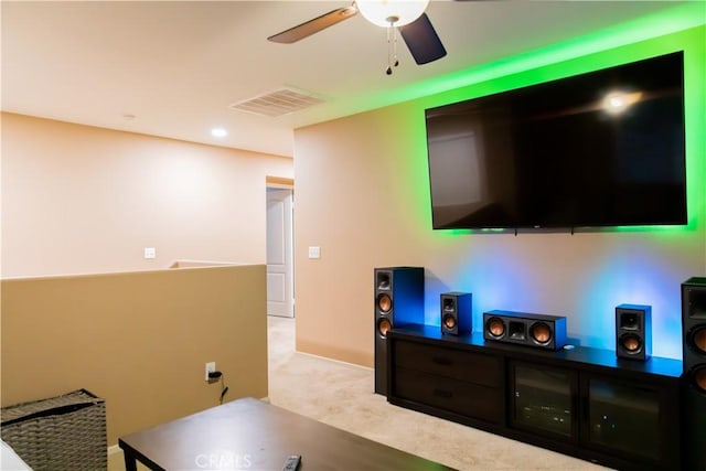 carpeted living room featuring ceiling fan