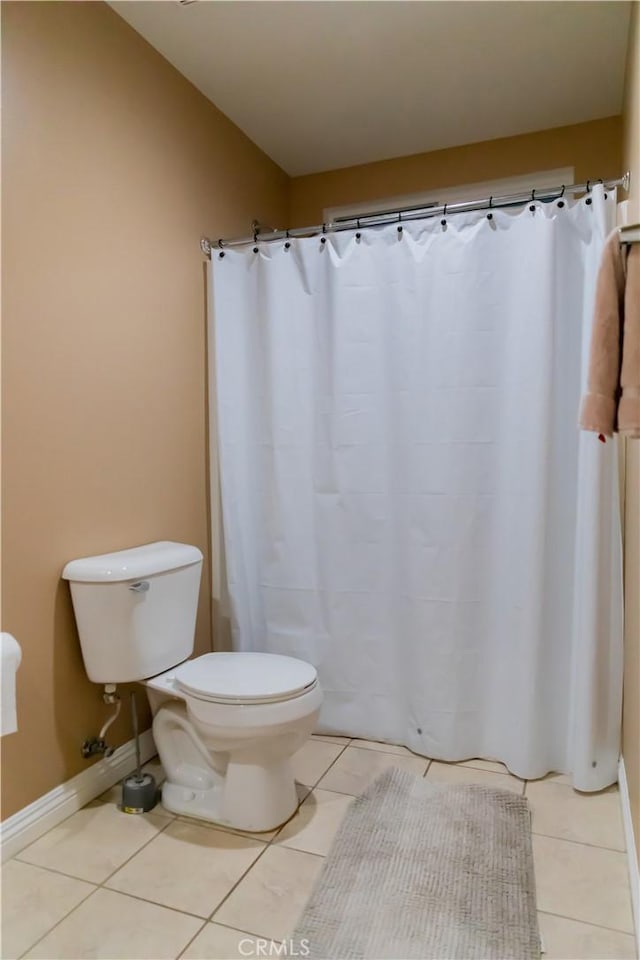 bathroom with tile patterned floors and toilet