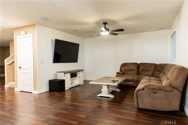 living room with ceiling fan and dark hardwood / wood-style floors