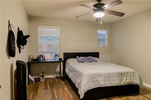 bedroom with ceiling fan and hardwood / wood-style flooring