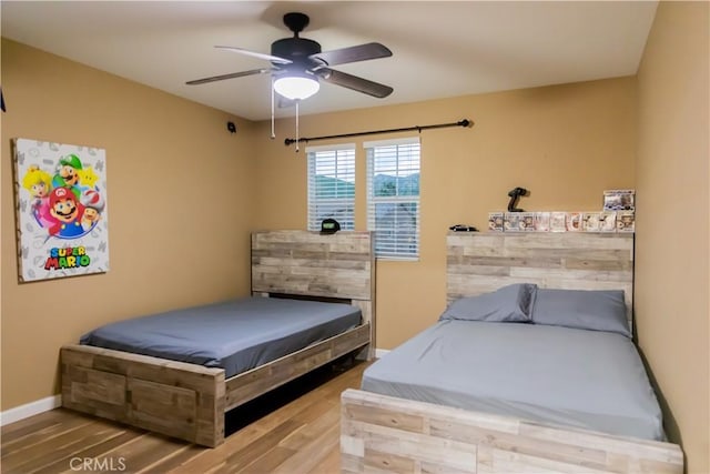 bedroom featuring ceiling fan and hardwood / wood-style flooring