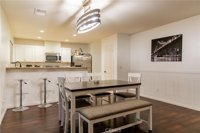 dining area featuring dark wood-type flooring