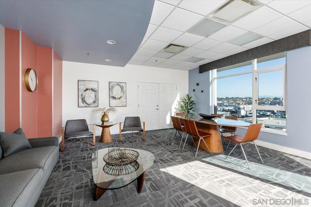 carpeted living room featuring a paneled ceiling