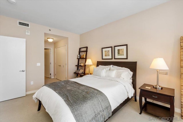 bedroom featuring light carpet