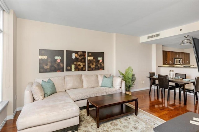 living room with ceiling fan and hardwood / wood-style flooring