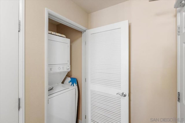 washroom featuring stacked washing maching and dryer