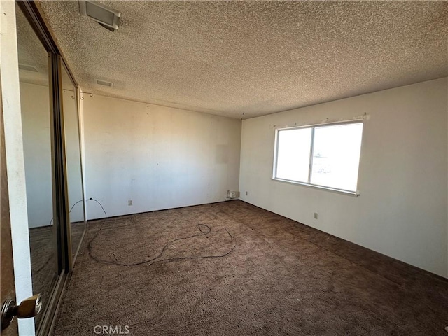 unfurnished bedroom with carpet floors and a textured ceiling