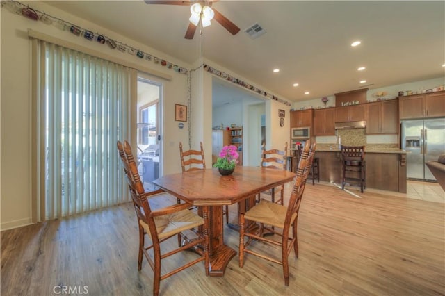 dining room featuring ceiling fan and light hardwood / wood-style floors