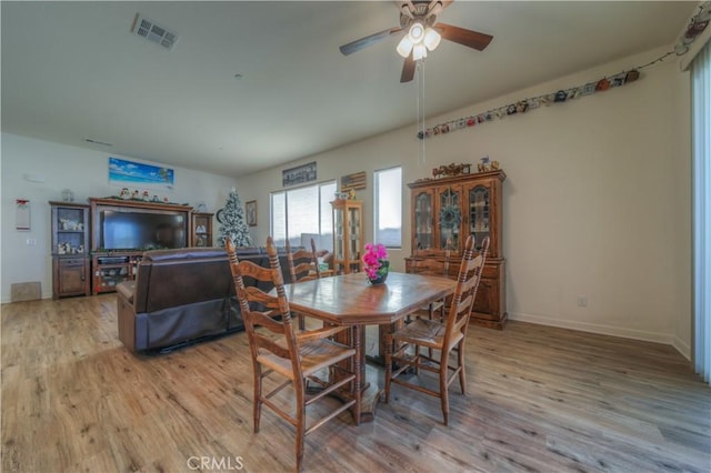 dining area with ceiling fan and light wood-type flooring