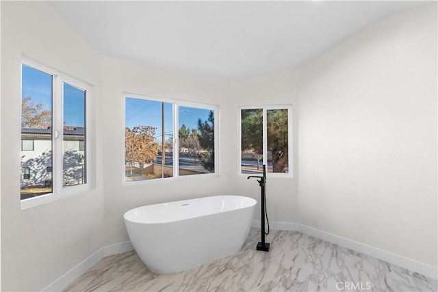 bathroom with a tub to relax in