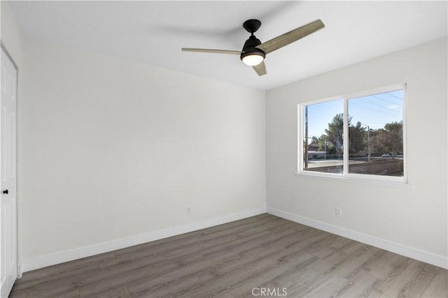 unfurnished room with ceiling fan and hardwood / wood-style flooring