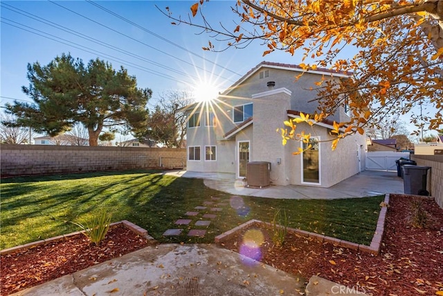 back of house with cooling unit, a lawn, and a patio