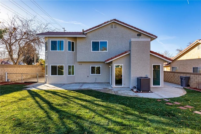 rear view of house featuring a yard, a patio, and central air condition unit