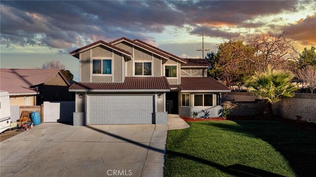 view of front of home featuring a garage and a yard