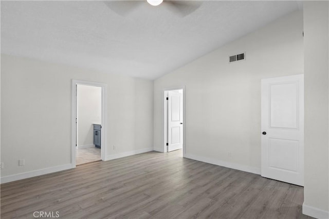 unfurnished room featuring light wood-type flooring, ceiling fan, and lofted ceiling