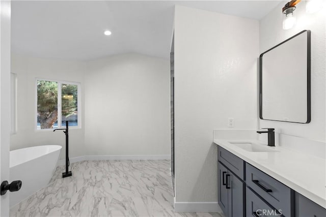 bathroom featuring vanity and a washtub