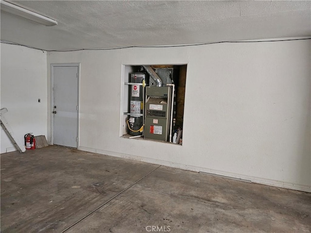 garage featuring heating unit and water heater