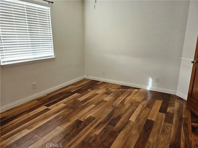 unfurnished room featuring dark wood-type flooring