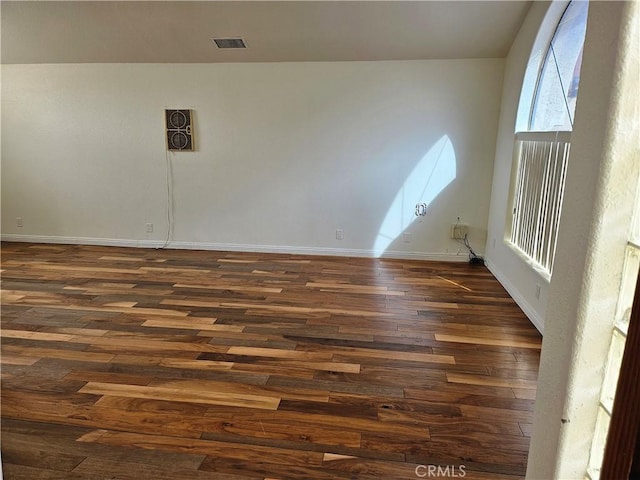 empty room with dark wood-type flooring