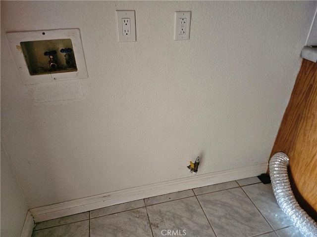 clothes washing area featuring washer hookup and light tile patterned floors