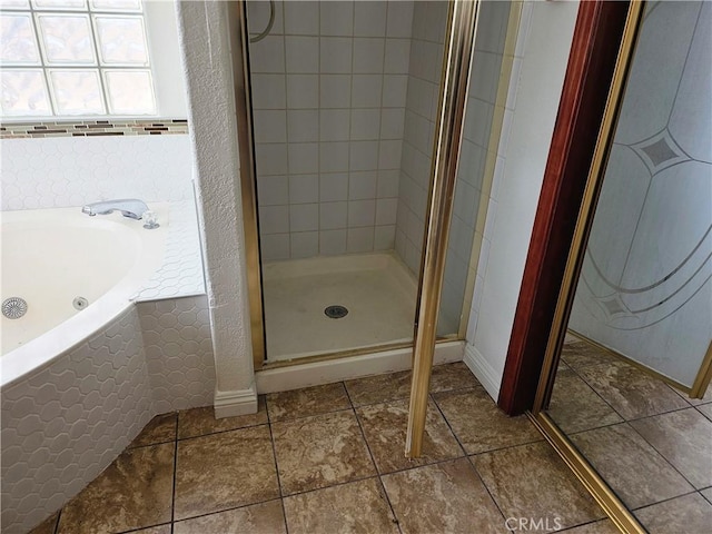 bathroom with shower with separate bathtub