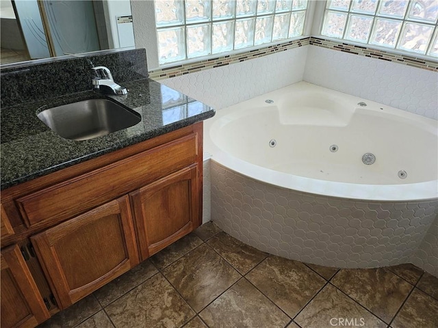 bathroom with a wealth of natural light, a tub to relax in, and vanity