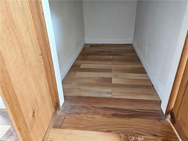 stairway with hardwood / wood-style flooring