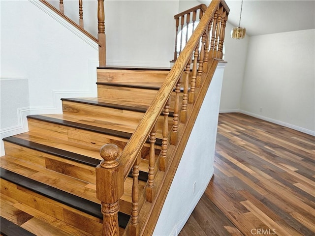 staircase with hardwood / wood-style floors