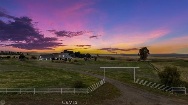 yard at dusk with a rural view