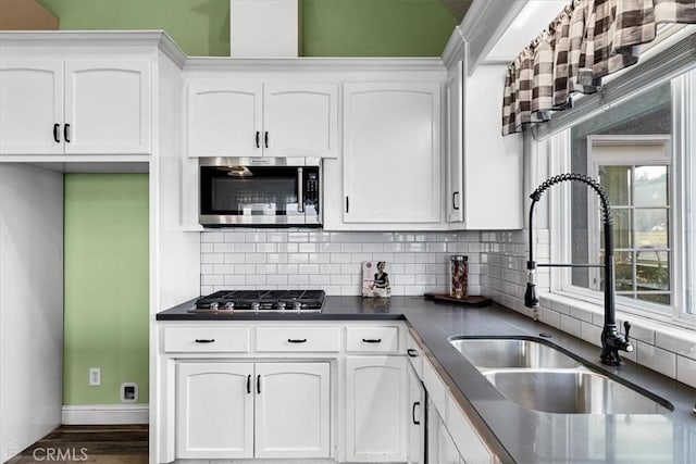 kitchen with stainless steel appliances and white cabinetry