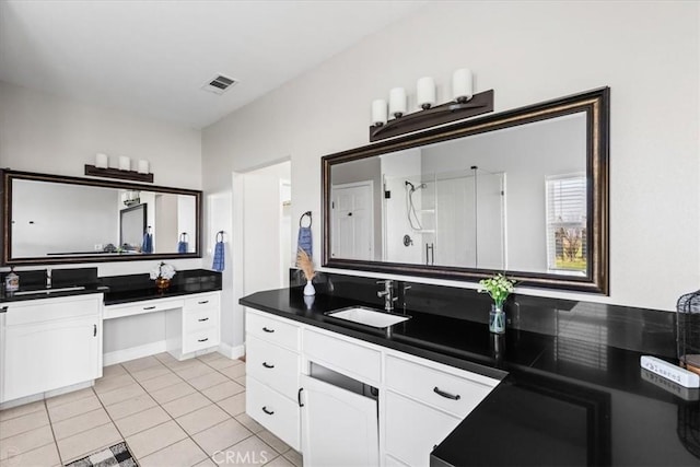 bathroom with vanity, a shower, and tile patterned floors