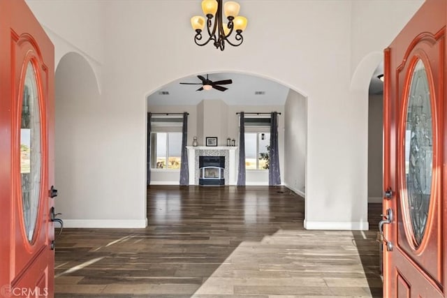 foyer entrance featuring ceiling fan with notable chandelier and hardwood / wood-style floors