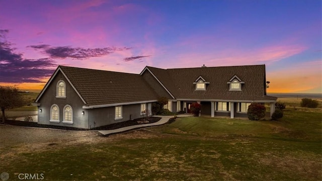 cape cod-style house with a yard