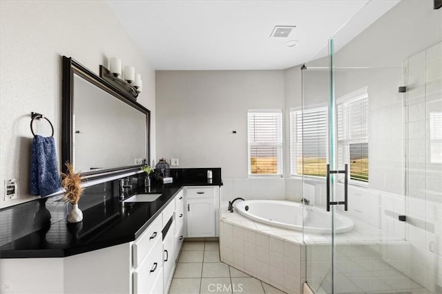 bathroom with tile patterned floors, vanity, and independent shower and bath