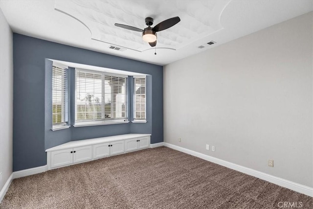 unfurnished room with ceiling fan and carpet flooring