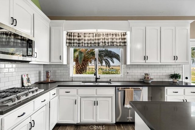 kitchen featuring sink, white cabinets, stainless steel appliances, and a healthy amount of sunlight