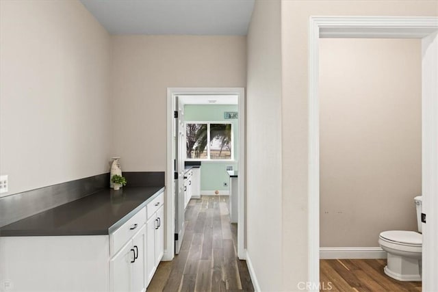 bathroom with hardwood / wood-style floors and toilet