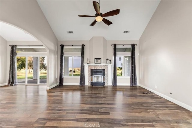 unfurnished living room featuring ceiling fan, vaulted ceiling, and dark wood-type flooring