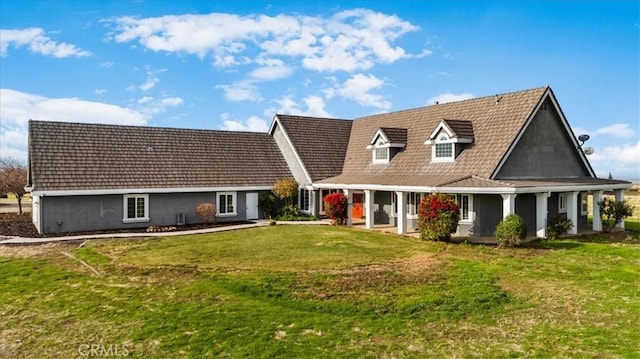 rear view of property with a lawn