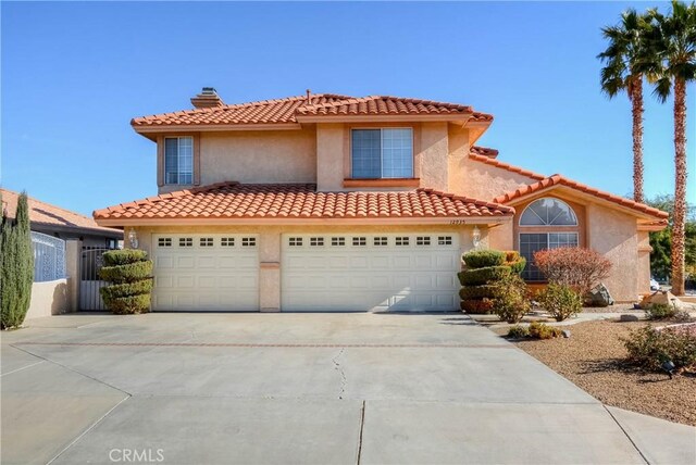 mediterranean / spanish house with a garage